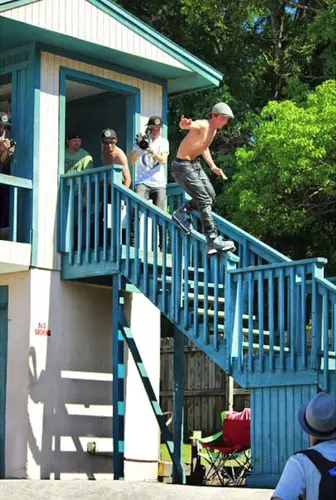 Ben Weis impressing the crowd with a huge gap to sould grind on a drop rail.