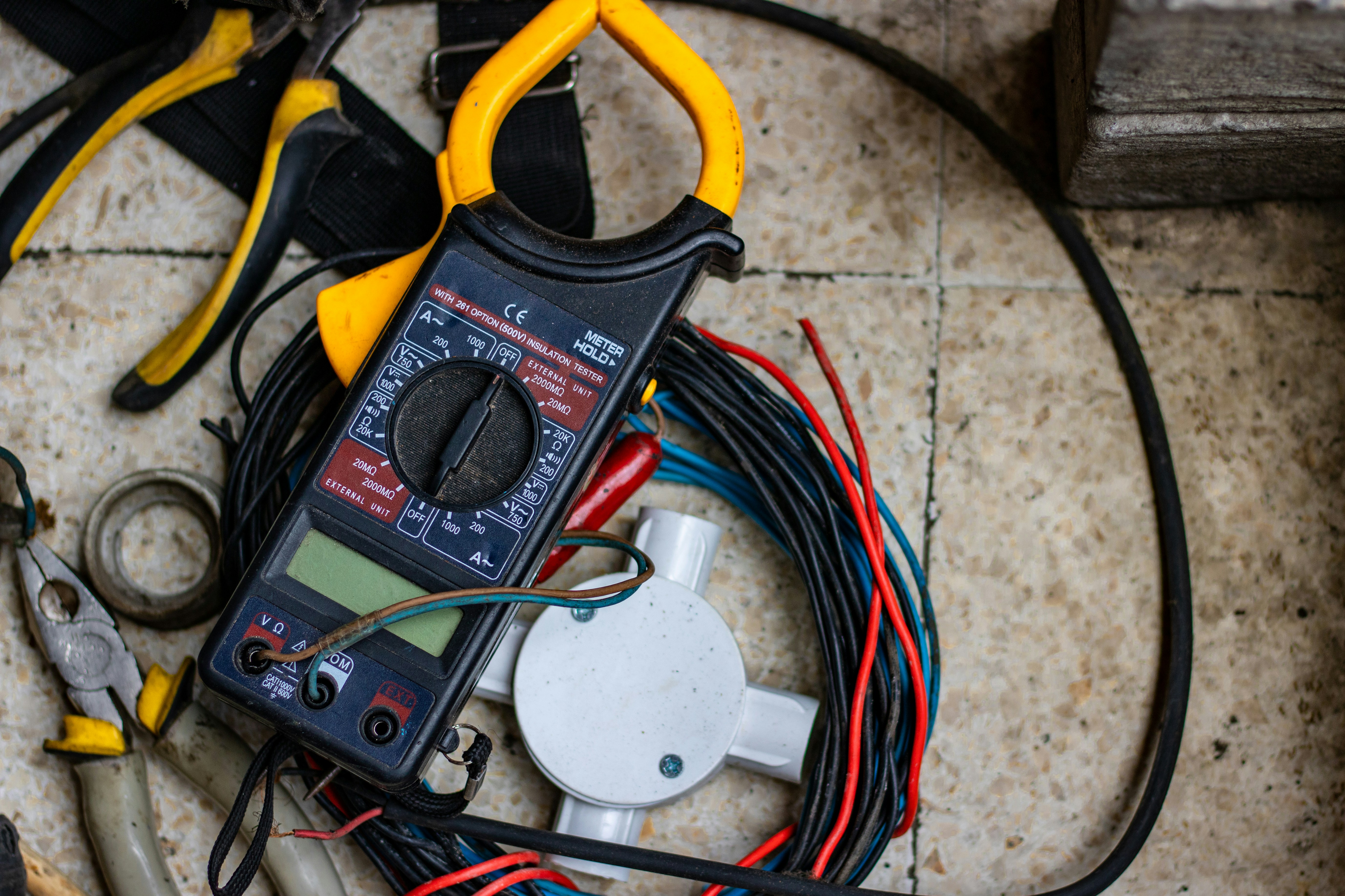 Electrician inspecting an outlet box during a diagnostic visit