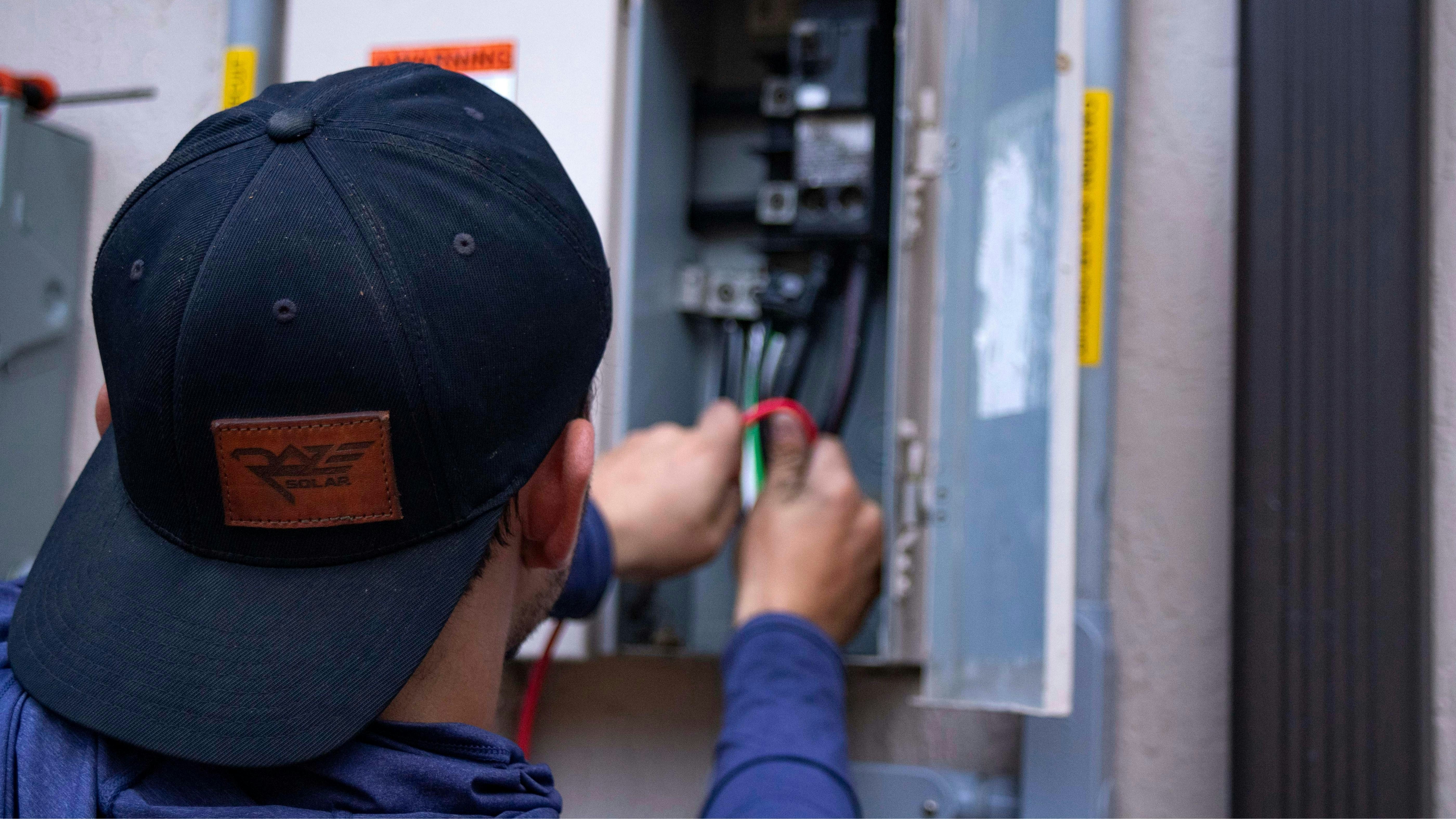 Electrician using a voltage tester on a residential circuit