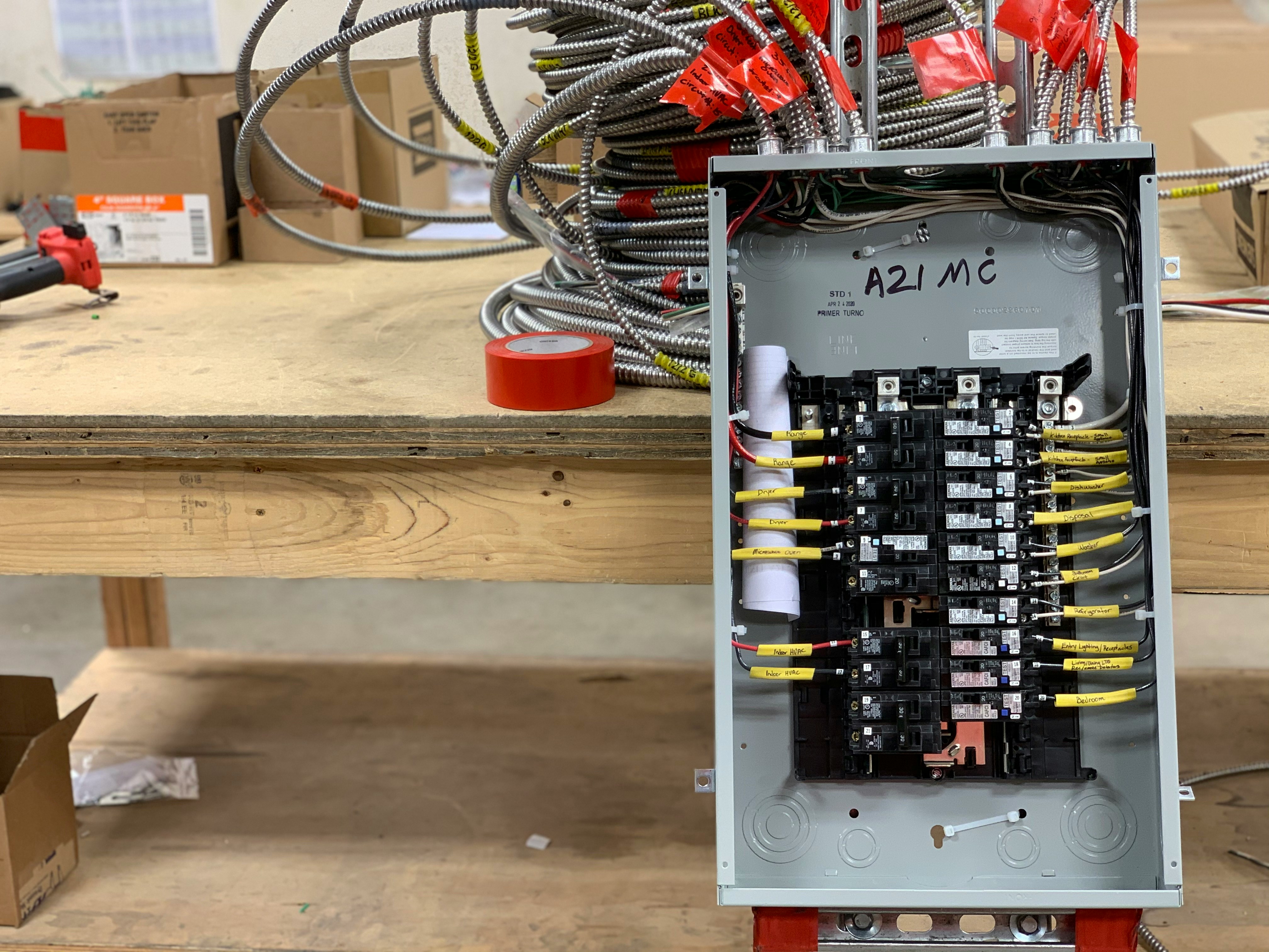 Electrician tracing a circuit with a meter at an outlet box