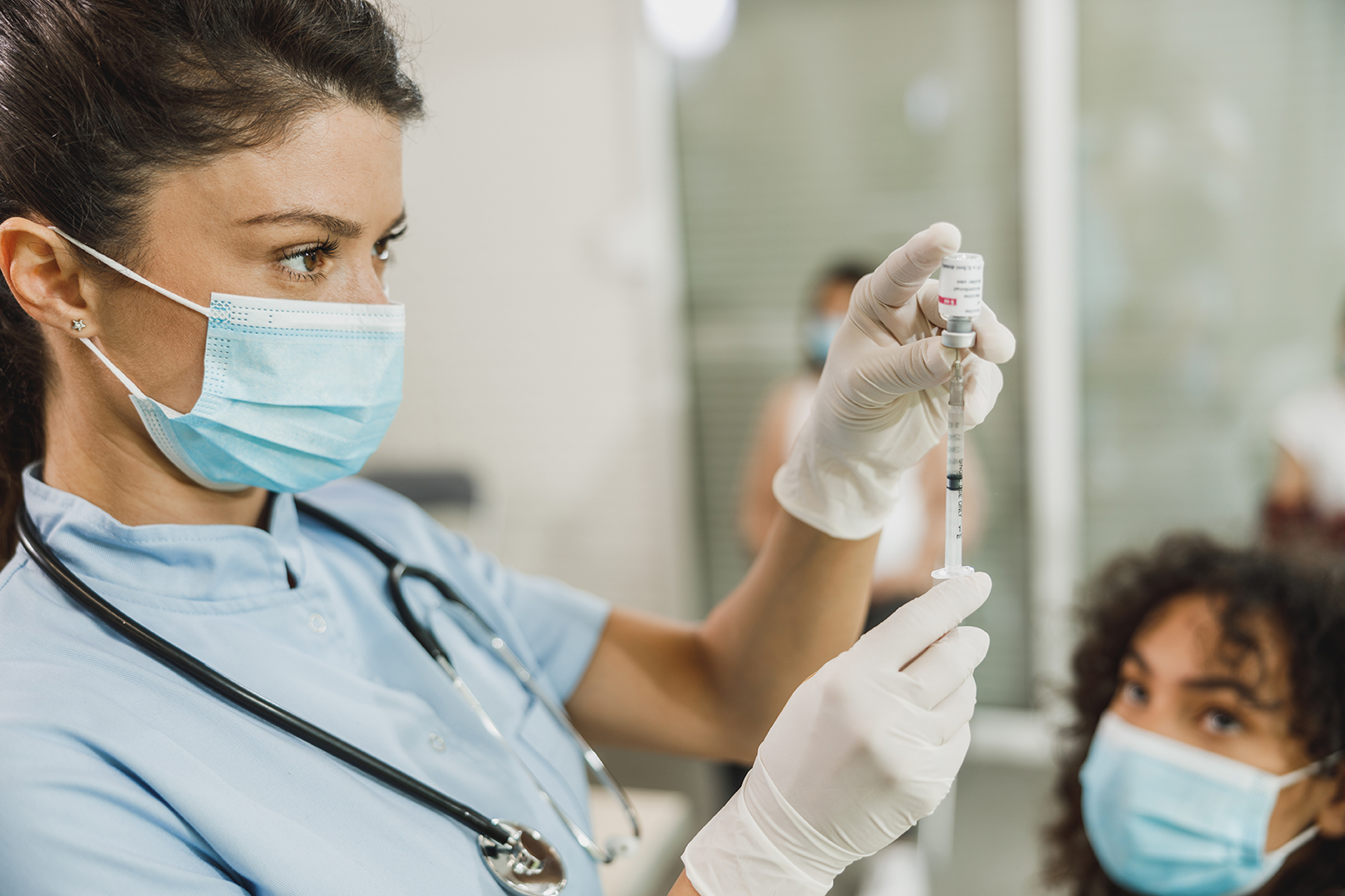Nurse Holding Coronavirus Vaccine and Syringe